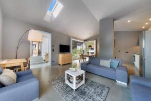 a living room with two blue couches and a table at Apartment Am Grübl in Lana