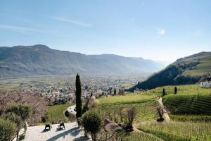 a group of people walking down a hill with a valley at Apartment Am Grübl in Lana