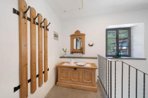 a room with a staircase with a table and a window at Apartment Am Grübl in Lana +23 photos