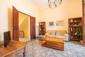 a living room with a couch and a tv at Cas Sitger in Felanitx