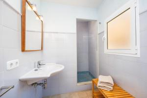 a white bathroom with a sink and a shower at Cas Sitger in Felanitx +29 photos