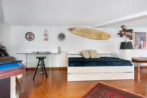 a bedroom with a bed with a surfboard on the wall at Loft la Matanza in La Matanza de Acentejo +30 photos