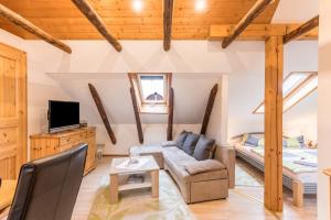 a large living room with a couch and a bed at Ferienwohnung Adler in Wirdum