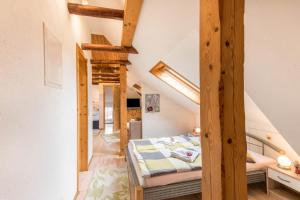a bedroom with a bed in a room with wooden beams at Ferienwohnung Adler in Wirdum