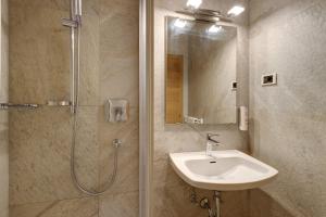 a bathroom with a sink and a shower at Premium App Hofer Barbara in Villabassa +19 photos