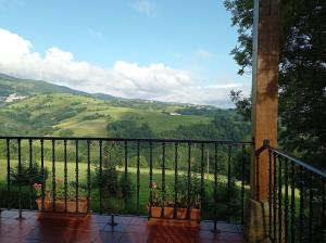 a balcony with a view of a green valley at Lokate 5 Habitaciones in Aia