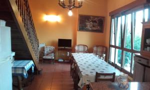 a dining room with tables and chairs and a television at Lokate 5 Habitaciones in Aia