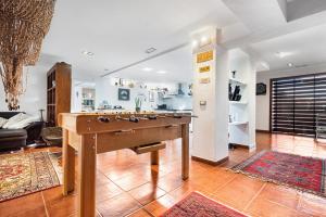 a living room with a pool table in the middle of a room at Loft la Matanza in La Matanza de Acentejo