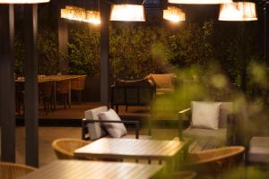 a restaurant with a table and chairs and lights at Hotel Terrado Lyon in Santiago