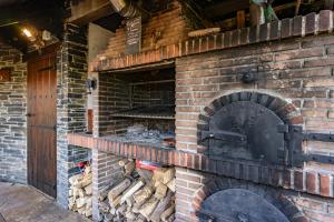 a brick oven with a fire inside of it at Mr de Alborada del eo in Villameitide