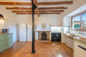 a kitchen with a stove and a fireplace at Finca Can Menut in Felanitx