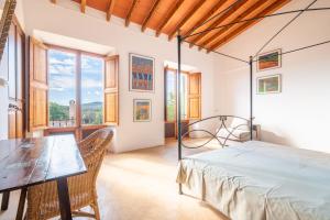 a bedroom with a bed and a table and chairs at Finca Can Menut in Felanitx +32 photos