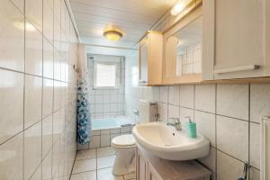 a small bathroom with a sink and a toilet at Ferienwohnung Lichte in Medebach +21 photos