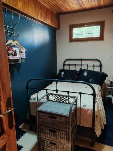 a bedroom with a bed and a blue wall at Chalet Vététiste in Laveissière
