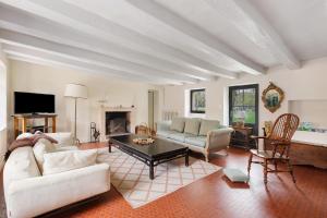 a living room with a couch and a table at La Petite Trigalière in Ambillou