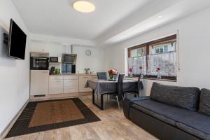 a living room with a couch and a table at Ferienwohnung Santa Gabriella in Herbolzheim