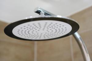 a close up of a shower head at Ferienwohnung Santa Gabriella in Herbolzheim +14 photos