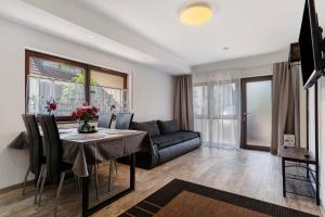 a living room with a table and a couch at Ferienwohnung Santa Gabriella in Herbolzheim