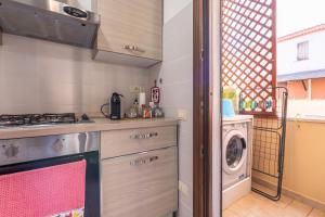 a kitchen with a stove and a washing machine at Queen's House in Pula +28 photos
