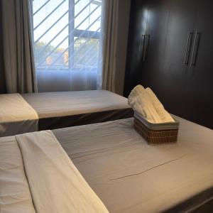 a hotel room with two beds and a window at Terrys place in Malmesbury