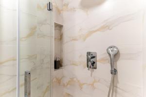 a bathroom with a shower with a glass door at Cala Azul-few steps from the beach in La Cala de Mijas +26 photos