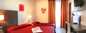 a living room with a red couch and a table at Hotel Venezia in Caorle