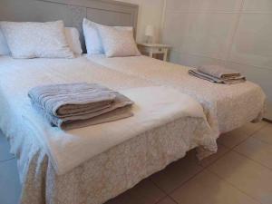 a bedroom with a bed with towels on it at CasaFelix in Corralejo +24 photos