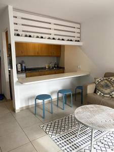 a kitchen with two blue stools and a table at CasaFelix in Corralejo
