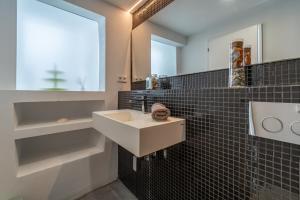 a bathroom with a sink and a mirror at Casa Sorteta, en el centro de Artà in Artá +13 photos