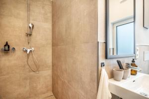 a bathroom with a shower and a sink at Moselbude Kröv mit Sauna in Kröv +22 photos