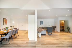 a dining room and living room with a table and chairs at Moselbude Kröv mit Sauna in Kröv