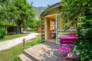 a house with a purple bench on a wooden porch at Roulotte insolite terrasse nature 1 in Touët-sur-Var