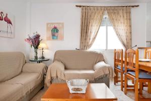 a living room with a couch and a table at Sagasta 1 - Andalmar in Conil de la Frontera