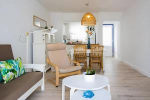 a living room with a couch and a table at Bungalow 2 - Caleta Campos in Arrieta