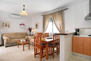 a kitchen and living room with a table and chairs at Sagasta 1 - Andalmar in Conil de la Frontera