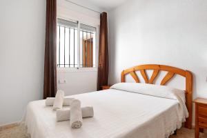 a bedroom with two beds and a window at Sagasta 1 - Andalmar in Conil de la Frontera