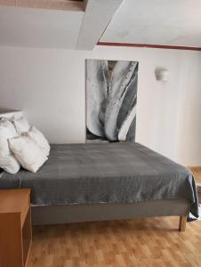 a bedroom with a bed with a painting on the wall at Unique apartahotel 2-1 in Torrevieja +2 photos