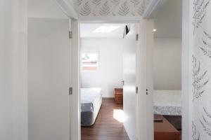 a bedroom with a bed and a door to a room at Moradia Pinheiro Manso in Apúlia +32 photos