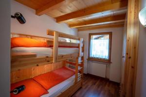a room with two bunk beds in a cabin at Appartamento Bucaneve in Predazzo