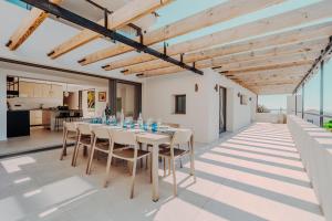 a dining room with a table and chairs at La Thébaïde in Cargèse