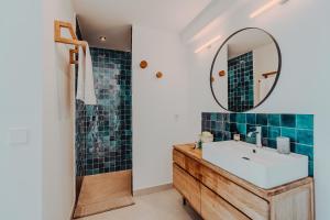 a bathroom with a sink and a mirror at La Thébaïde in Cargèse +32 photos