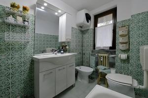 a bathroom with a sink and a toilet at Maison Wanda La Salle in La Salle +12 photos