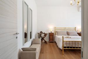 a bedroom with a bed and a couch and a chair at Dante210 in Cassina Rizzardi