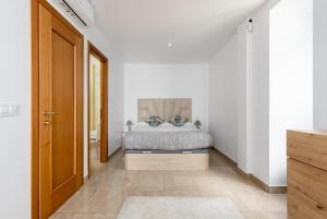 a bedroom with a bed in a white room at Atico Duplex con terraza in Manilva +27 photos
