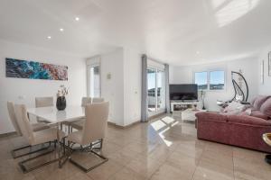 a living room with a red couch and a table at Atico Duplex con terraza in Manilva