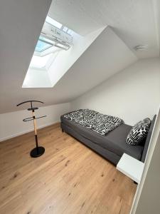 a bedroom with a black bed and a skylight at Ferienwohnung Kastellaun in Kastellaun
