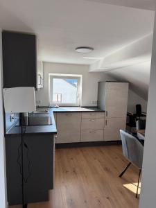 a large kitchen with a counter and a window at Ferienwohnung Kastellaun in Kastellaun