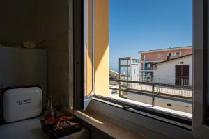 a window in a room with a view of a balcony at La casa di Greta in Marcelli