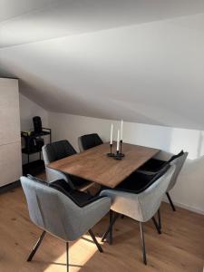 a dining room table with chairs and candles on it at Ferienwohnung Kastellaun in Kastellaun