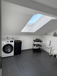 a bathroom with a washing machine and a window at Ferienwohnung Kastellaun in Kastellaun +9 photos